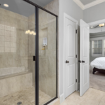 bathroom with a large shower and the door open