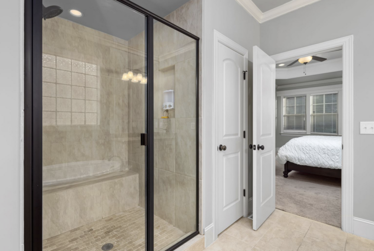 bathroom with a large shower and the door open