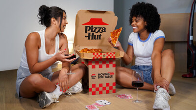 new table box from pizza hut two women enjoying pizza on the floor